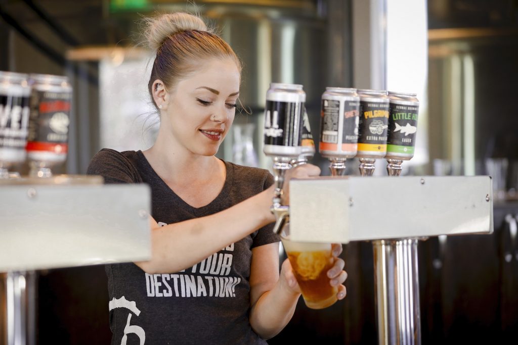 Bartender pouring Vernal Brewing beers in Dinosaurland, Utah