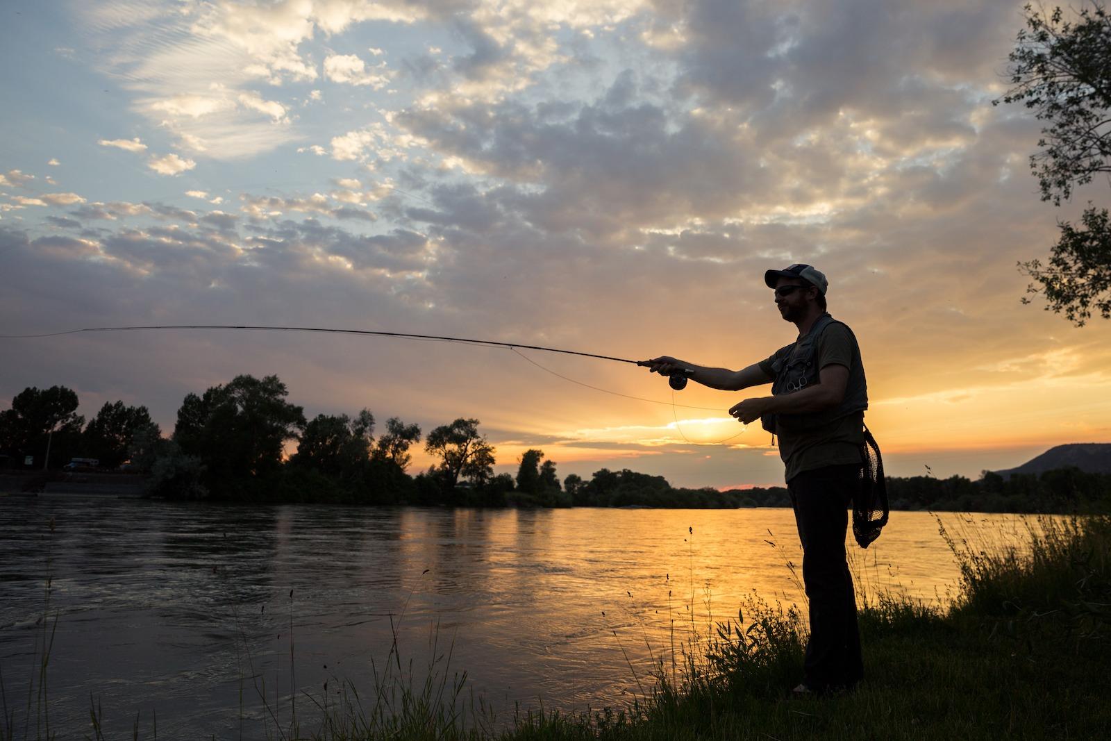 man fishing the shore of the Snake River in Idaho Falls