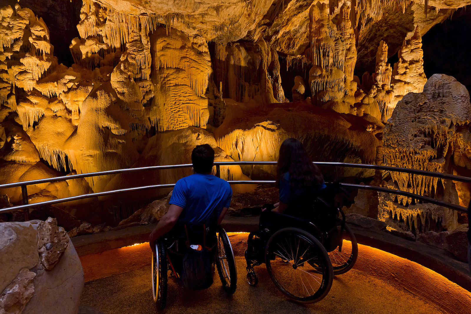Two people in wheelchairs in the caves of Kartchner Caverns in southern Arizona