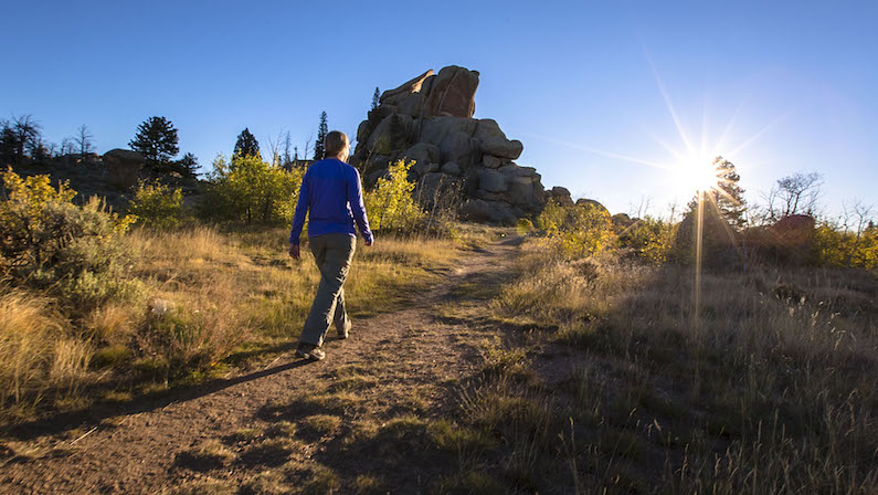 Woman on hiking trail in Laramie in the summer at Vedauwoo