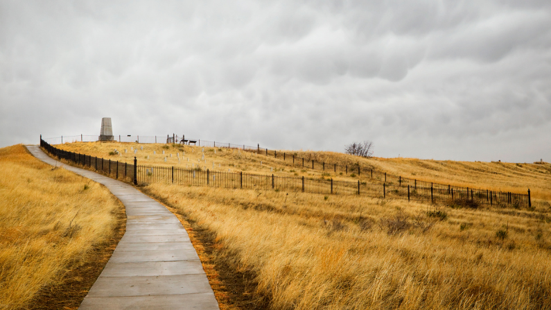 A sidewalk leading to a cemetery on a hill at Little Bighorn Battlefield National Monument 