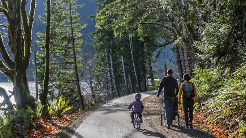 Family biking and walking on Spruce Railroad Trail