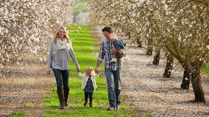 Family walking through you-pick farm in Central Valley of California