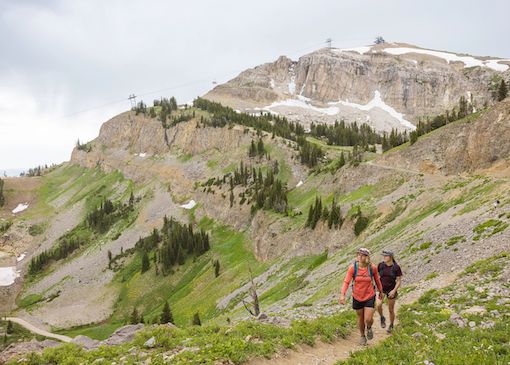 Two hikers hike from the top at Jackson Hole Mountain Resort