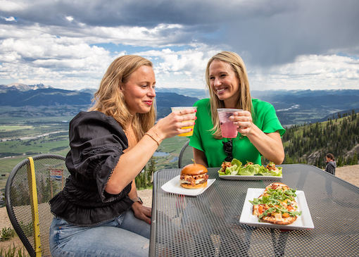 Diners toasting over a meal at the top of the Jackson Hole Mountain Resort mountain