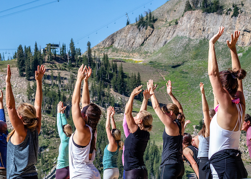 Yoga class with mountain scenery behind