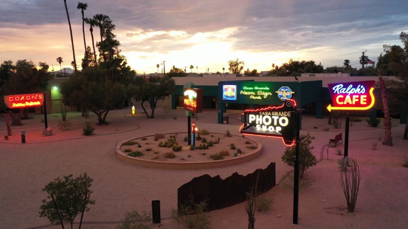 The sun sets behind Casa Grande, Arizona's Neon Sign Park